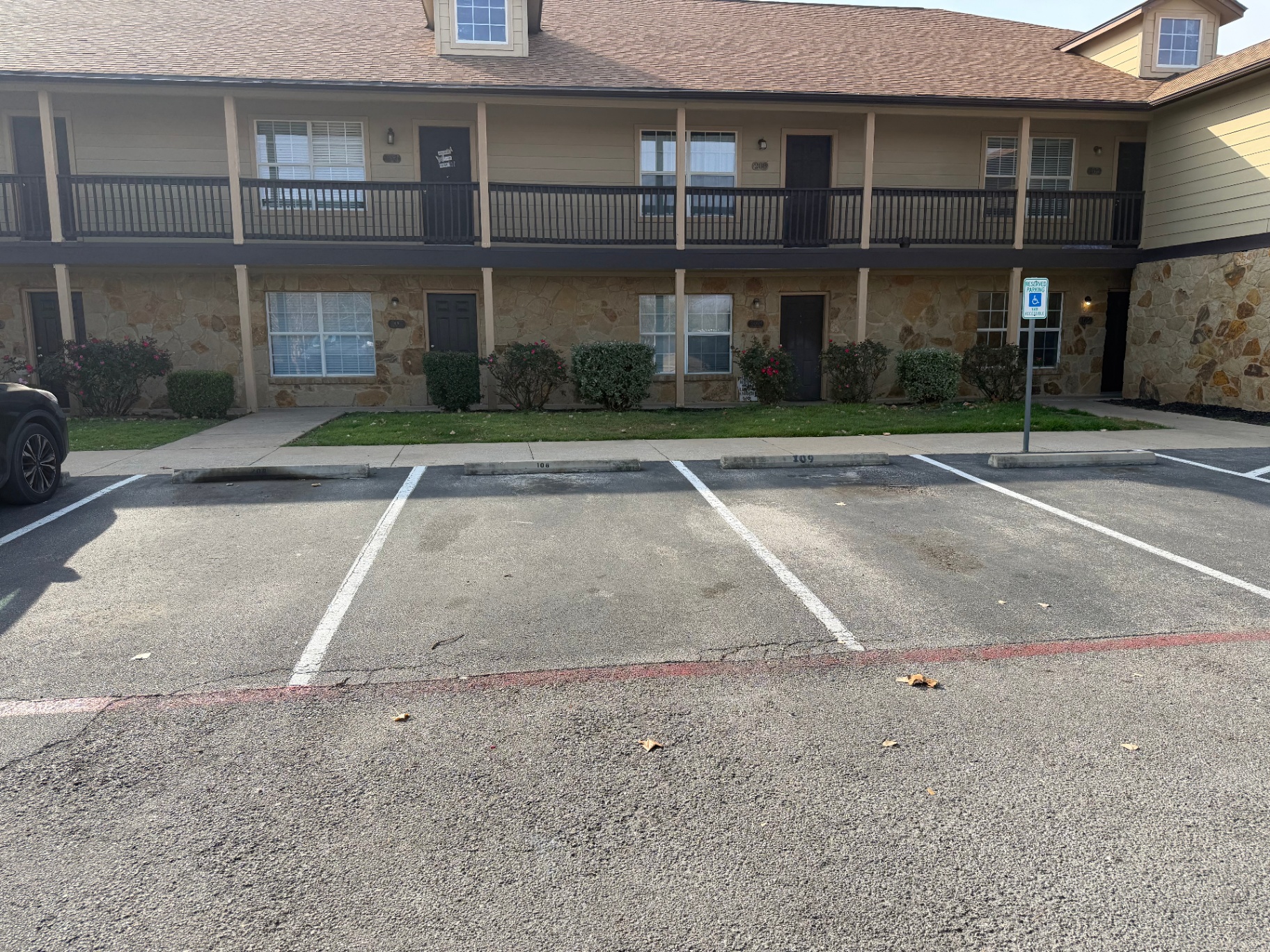 Surface parking spaces along one of the buildings