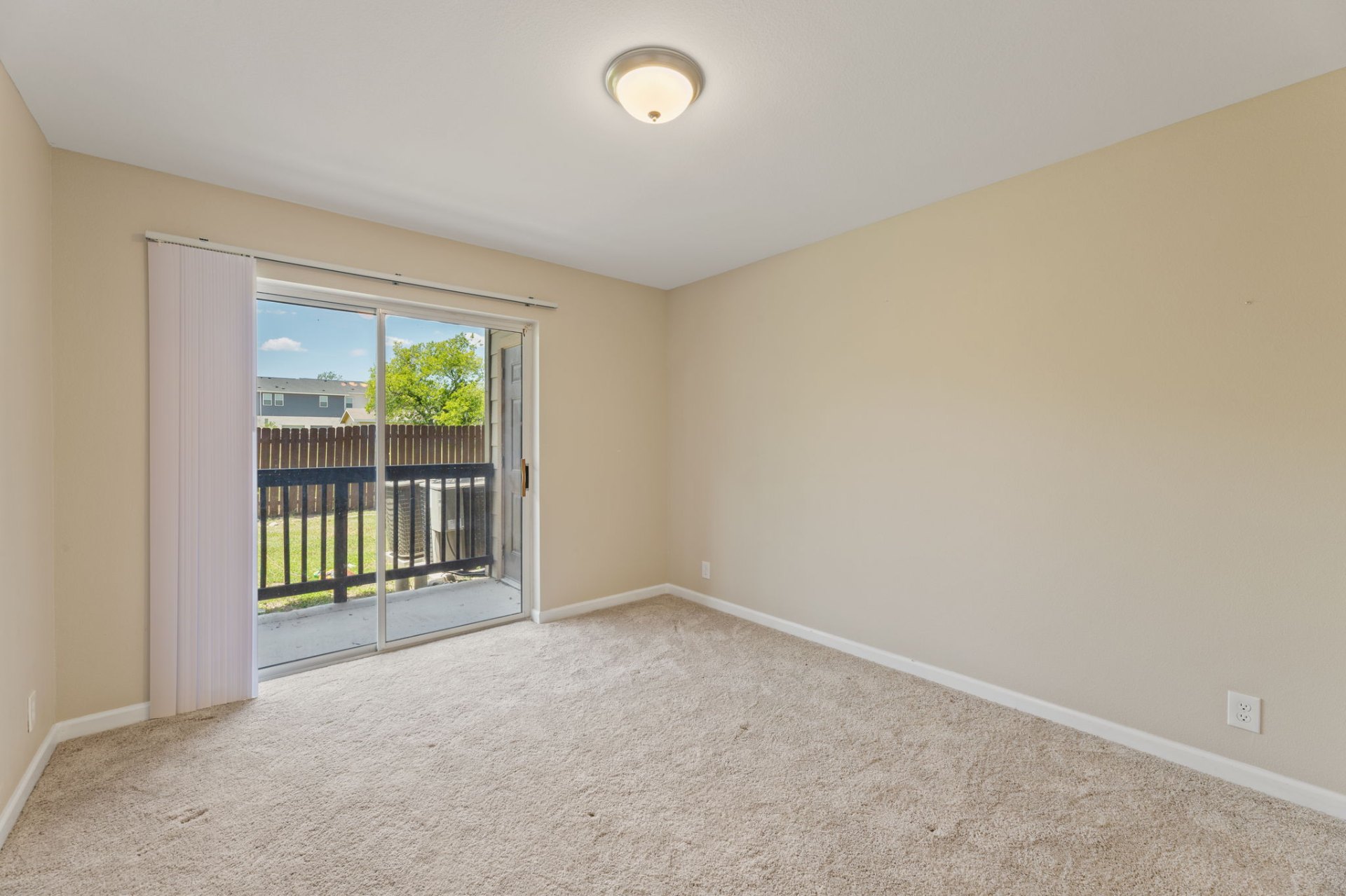 Bright bedroom with sliding glass door to patio
