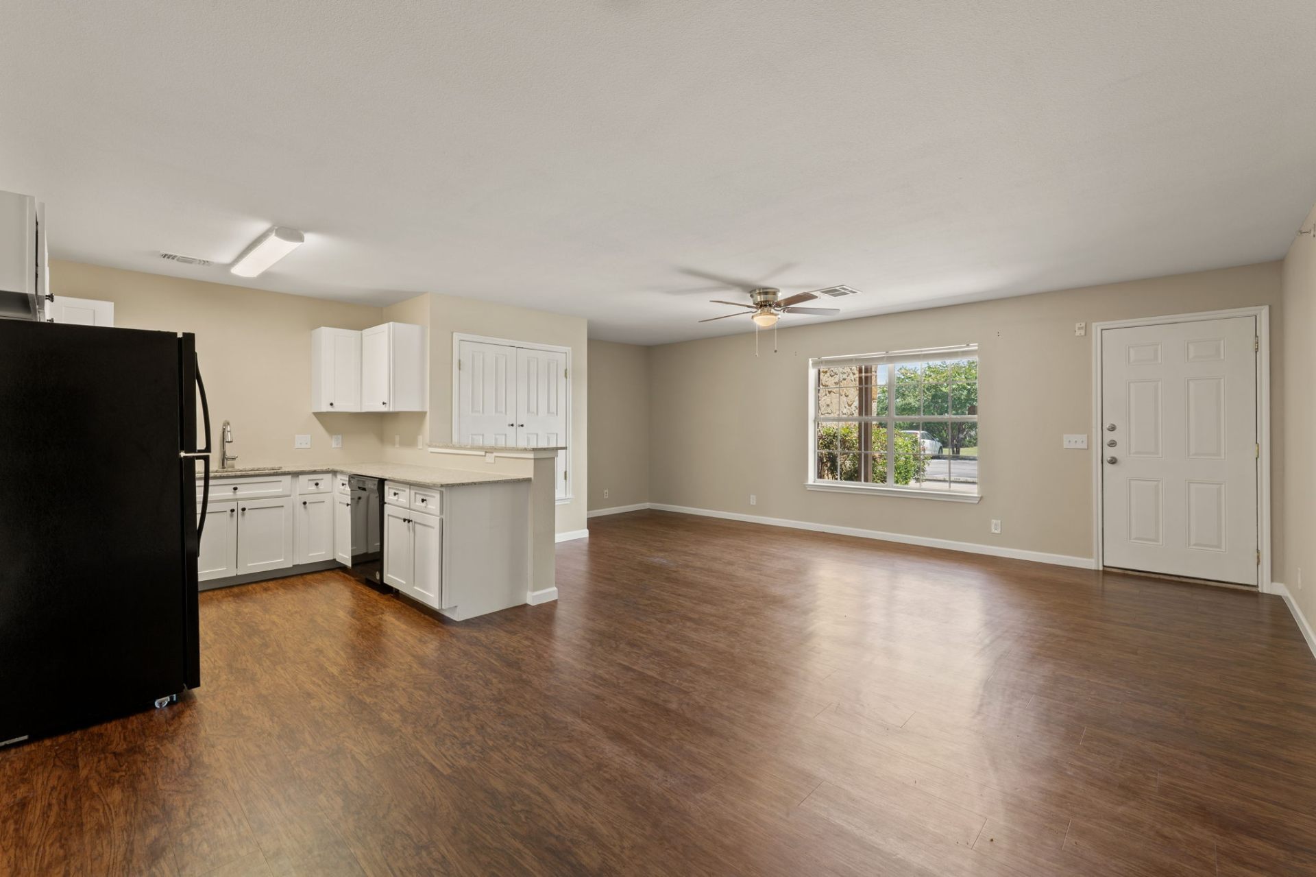 Open-concept living room and kitchen with natural light