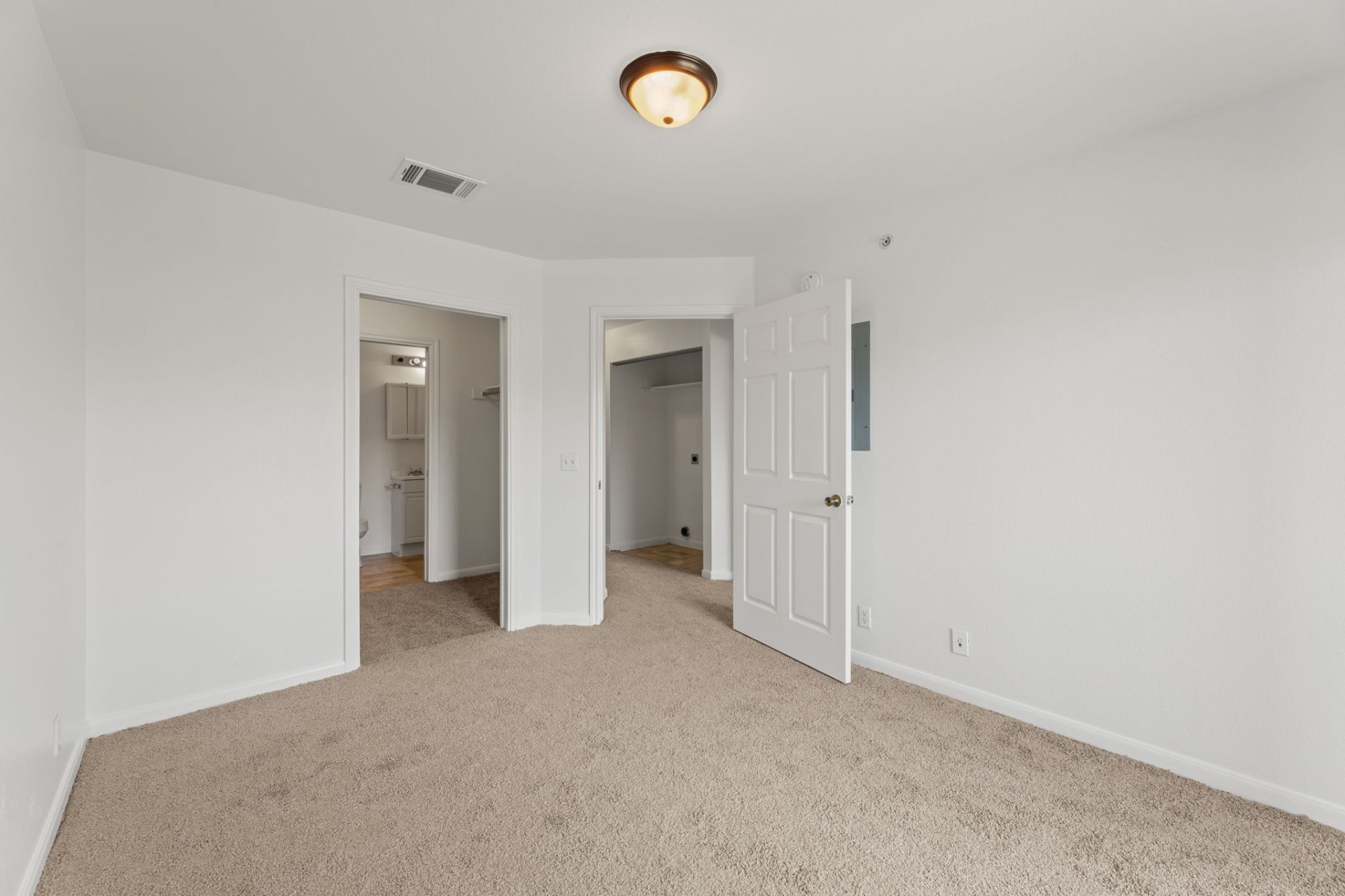 Classic-finish bedroom with carpet, en-suite bath, and closet access