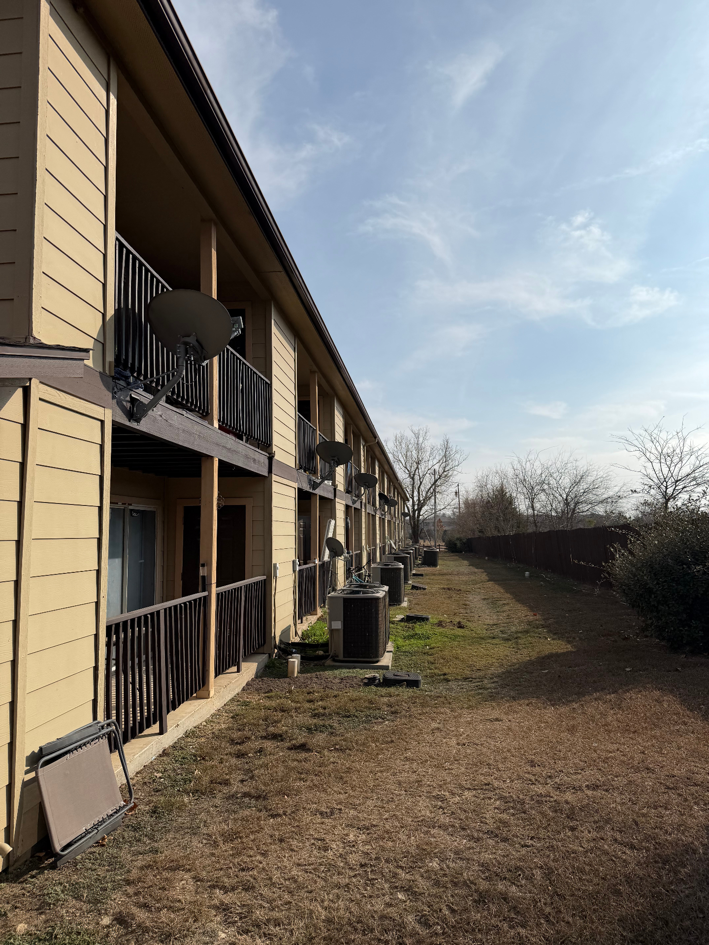 Rear side of the buildings with private patios and yard