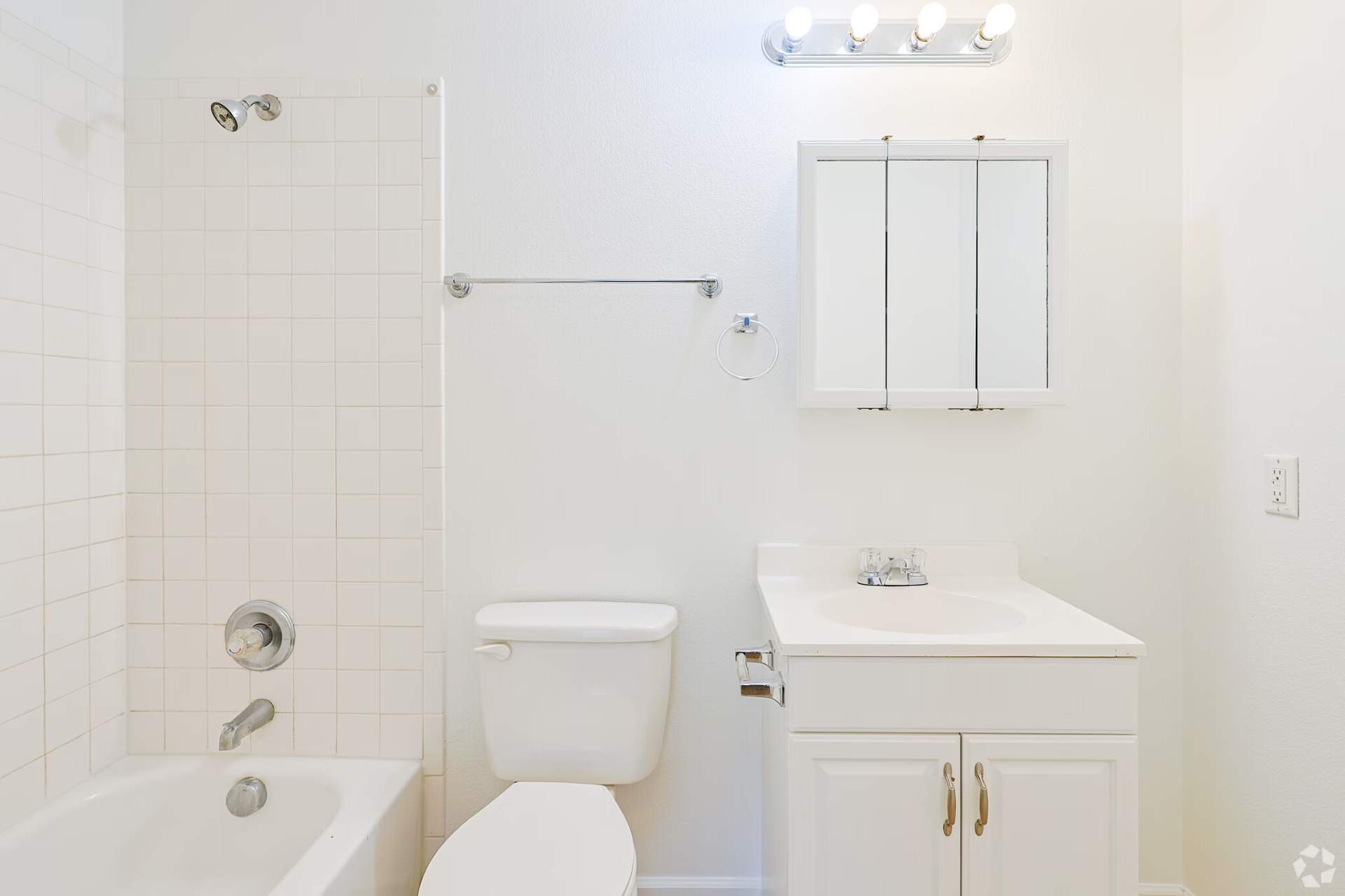 Classic-finish bathroom with white tile tub surround and laminate vanity
